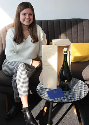 Customer with a champagne magnum and a wooden box
